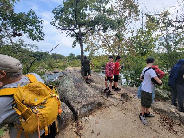 Scouts hiking across a rocky ridge trail